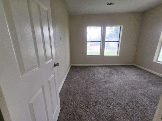 1300 Burbank St, Baytown, TX 77520 - carpeted empty room with healthy amount of natural light and baseboards