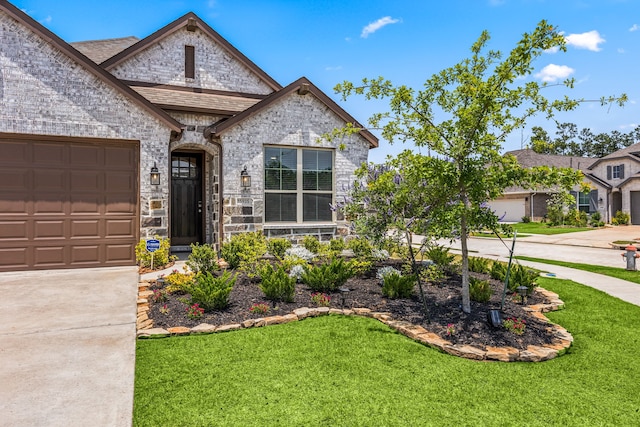 view of front of home with concrete driveway, a front yard, a garage, and brick siding