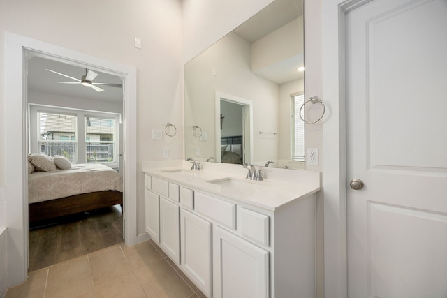 ensuite bathroom featuring a ceiling fan, tile patterned floors, and double vanity