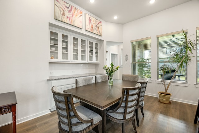 dining area with baseboards, dark wood-style floors, and recessed lighting
