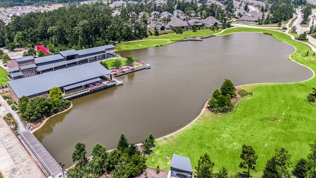 drone / aerial view of a large body of water and a tree filled landscape