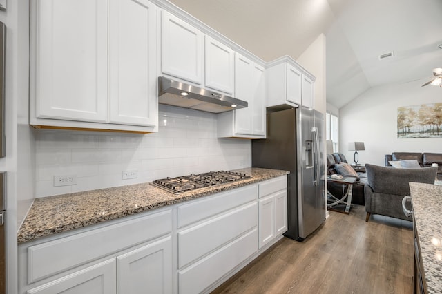 kitchen featuring appliances with stainless steel finishes, under cabinet range hood, wood finished floors, open floor plan, and white cabinets