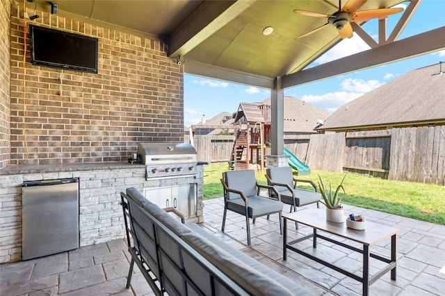 2023 Aspen Point Ln, Richmond, TX 77469 - view of patio with area for grilling, an outdoor living space, an outdoor kitchen, a playground, and a ceiling fan