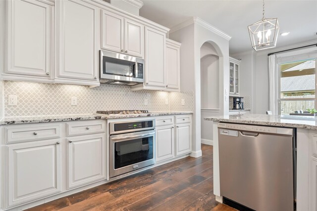 2023 Aspen Point Ln, Richmond, TX 77469 - kitchen featuring appliances with stainless steel finishes, ornamental molding, dark wood-style floors, a chandelier, and white cabinetry