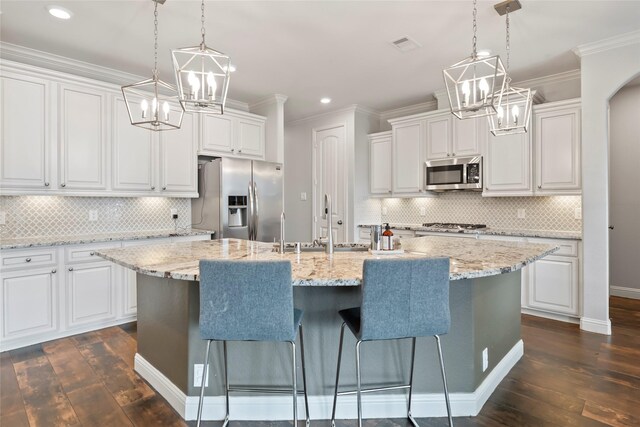 2023 Aspen Point Ln, Richmond, TX 77469 - kitchen featuring appliances with stainless steel finishes, dark wood-type flooring, recessed lighting, tasteful backsplash, and crown molding