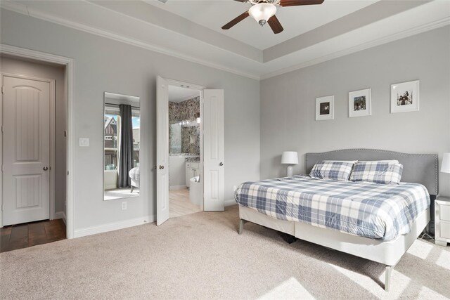 2023 Aspen Point Ln, Richmond, TX 77469 - carpeted bedroom featuring crown molding, baseboards, ceiling fan, a tray ceiling, and ensuite bathroom