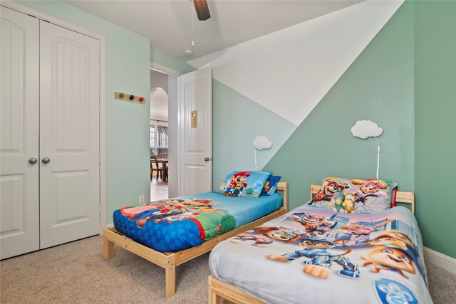 2023 Aspen Point Ln, Richmond, TX 77469 - carpeted bedroom with a closet, arched walkways, ceiling fan, and baseboards