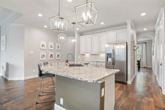 2023 Aspen Point Ln, Richmond, TX 77469 - kitchen featuring stainless steel fridge with ice dispenser, a sink, dark wood-style floors, ornamental molding, and baseboards