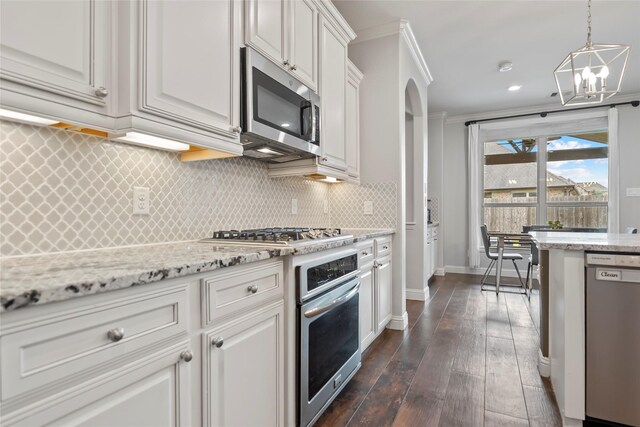 2023 Aspen Point Ln, Richmond, TX 77469 - kitchen with stainless steel appliances, a chandelier, decorative backsplash, dark wood-style floors, and arched walkways