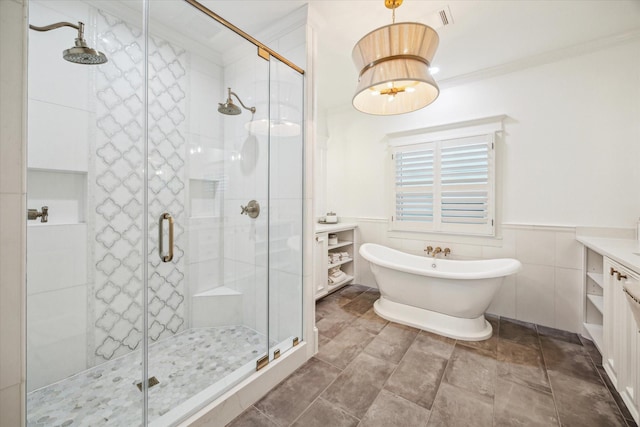 300 E 26th St, Houston, TX 77008 - full bathroom with vanity, a shower stall, a freestanding tub, ornamental molding, and wainscoting