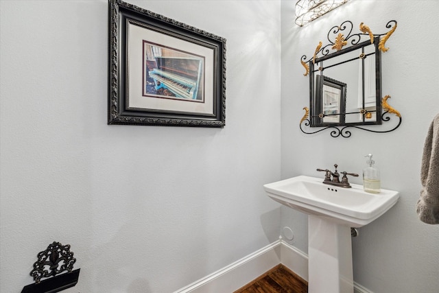 300 E 26th St, Houston, TX 77008 - bathroom with baseboards, wood finished floors, and a sink