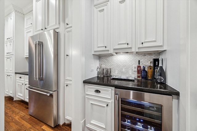 300 E 26th St, Houston, TX 77008 - kitchen featuring high quality fridge, wine cooler, white cabinetry, and backsplash