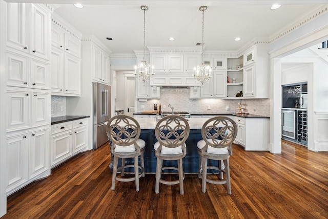 300 E 26th St, Houston, TX 77008 - kitchen with high end refrigerator, white cabinets, a chandelier, decorative backsplash, and recessed lighting