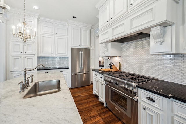 300 E 26th St, Houston, TX 77008 - kitchen with high quality appliances, a sink, white cabinetry, backsplash, and dark wood finished floors
