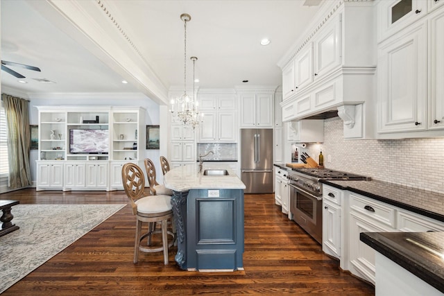 300 E 26th St, Houston, TX 77008 - kitchen with high quality appliances, white cabinets, a sink, ornamental molding, and a kitchen breakfast bar