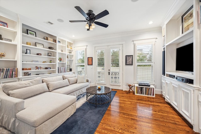 300 E 26th St, Houston, TX 77008 - living room with ornamental molding, wood finished floors, ceiling fan, baseboards, and built in shelves
