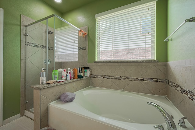 2812 Baywater Creek Ln, Pearland, TX 77089 - bathroom with a shower stall, a textured wall, and a bath
