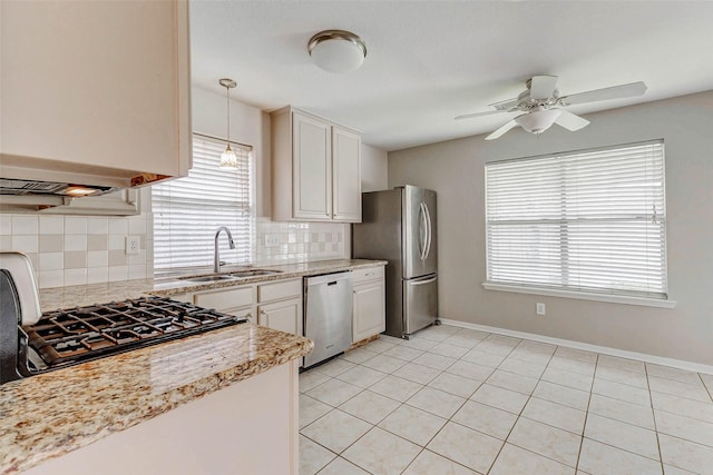 14418 Dunsmore Pl, Cypress, TX 77429 - kitchen with stainless steel appliances, plenty of natural light, ceiling fan, and backsplash