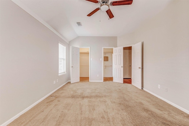 14418 Dunsmore Pl, Cypress, TX 77429 - unfurnished bedroom with vaulted ceiling, carpet floors, a walk in closet, and a ceiling fan
