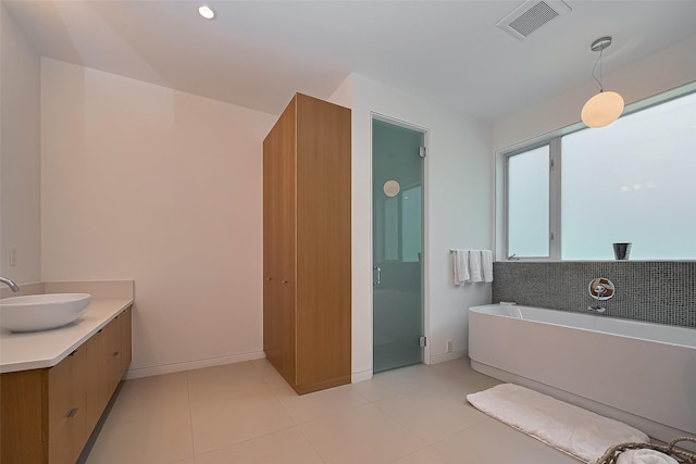 118 Angel Leaf Rd, The Woodlands, TX 77380 - full bath with a soaking tub, vanity, baseboards, and tile patterned flooring
