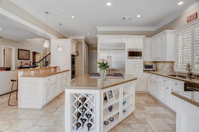19 Royal Hampton Ct, Sugar Land, TX 77479 - kitchen featuring built in appliances, a sink, crown molding, stone tile flooring, and decorative backsplash