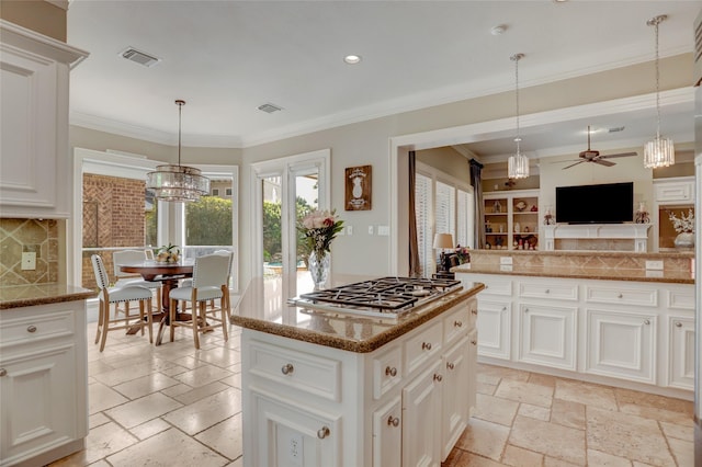 19 Royal Hampton Ct, Sugar Land, TX 77479 - kitchen with a ceiling fan, stainless steel gas stovetop, stone tile floors, a chandelier, and recessed lighting