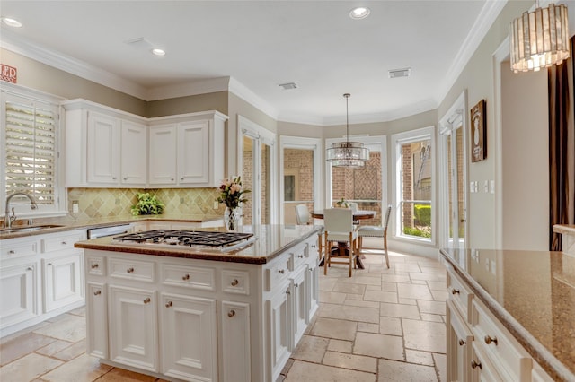 19 Royal Hampton Ct, Sugar Land, TX 77479 - kitchen with a sink, stone tile floors, stainless steel gas cooktop, dark stone counters, and recessed lighting