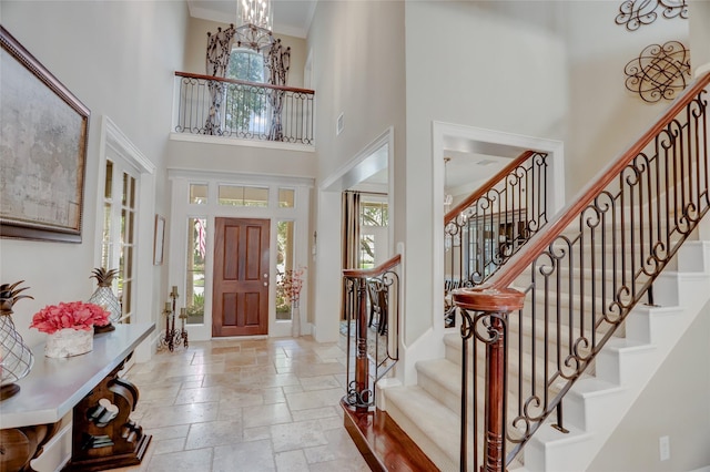 19 Royal Hampton Ct, Sugar Land, TX 77479 - entryway with a towering ceiling, stone tile floors, stairs, and baseboards