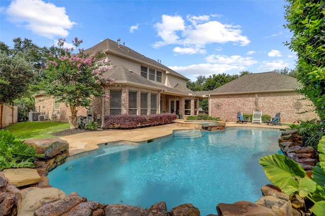 19 Royal Hampton Ct, Sugar Land, TX 77479 - view of swimming pool with a pool with connected hot tub, a patio, and central air condition unit