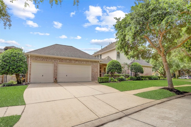 19 Royal Hampton Ct, Sugar Land, TX 77479 - view of front of house with brick siding, a garage, driveway, and a shingled roof