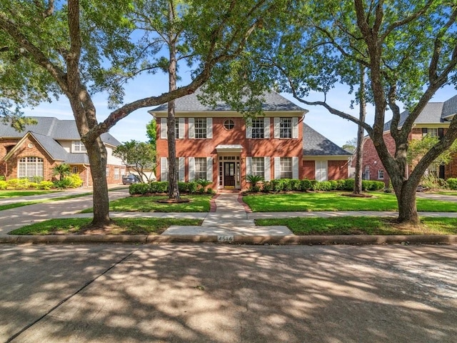 4614 Jamaica Dr, Sugar Land, TX 77479 - view of front of home with a front yard and brick siding