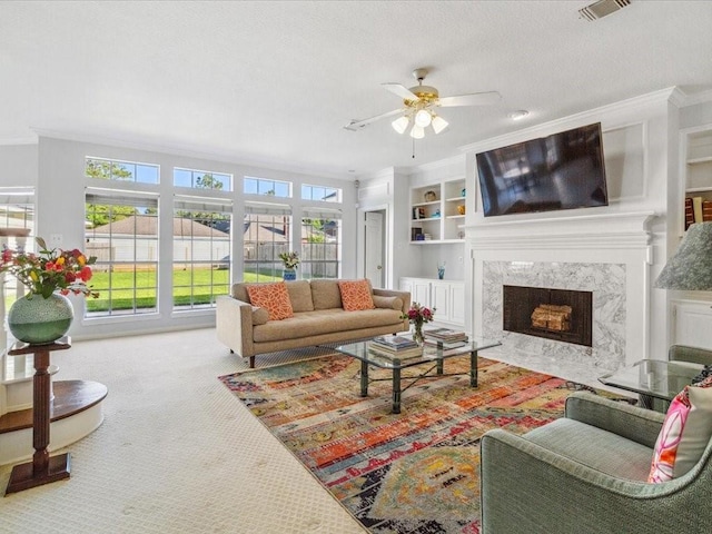 4614 Jamaica Dr, Sugar Land, TX 77479 - living room with a ceiling fan, carpet, ornamental molding, a fireplace, and built in shelves