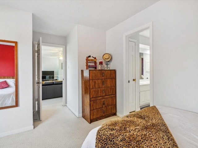 4614 Jamaica Dr, Sugar Land, TX 77479 - carpeted bedroom with connected bathroom and baseboards