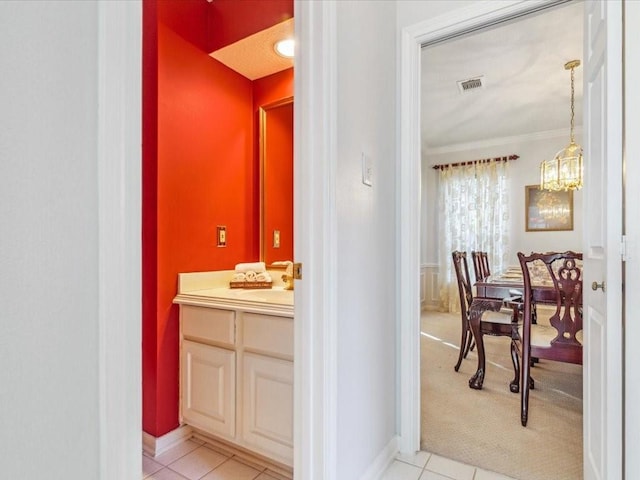4614 Jamaica Dr, Sugar Land, TX 77479 - bathroom featuring vanity, baseboards, ornamental molding, a chandelier, and tile patterned flooring