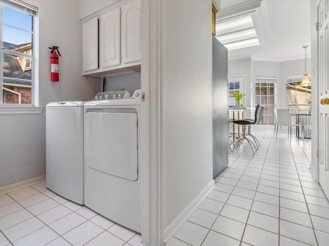 4614 Jamaica Dr, Sugar Land, TX 77479 - laundry area featuring cabinet space, separate washer and dryer, light tile patterned flooring, baseboards, and ornamental molding