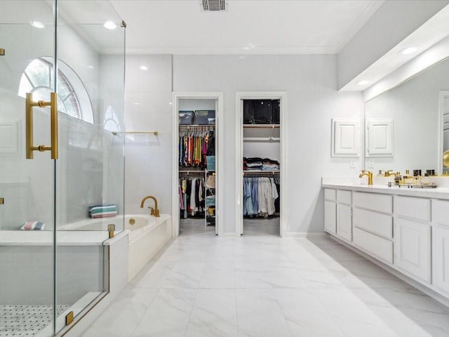 4614 Jamaica Dr, Sugar Land, TX 77479 - bathroom with double vanity, a stall shower, crown molding, a garden tub, and a spacious closet