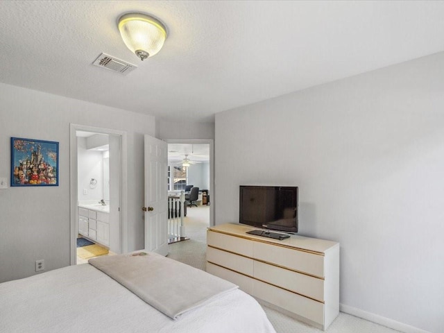 4614 Jamaica Dr, Sugar Land, TX 77479 - bedroom with connected bathroom and baseboards