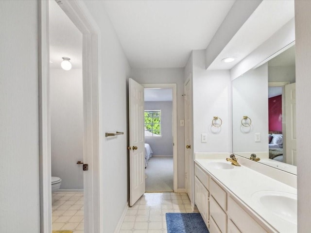 4614 Jamaica Dr, Sugar Land, TX 77479 - bathroom with connected bathroom, double vanity, toilet, tile patterned floors, and baseboards