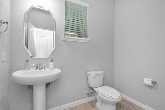 3804 Lancer Cir, Pearland, TX 77581 - half bathroom featuring toilet, baseboards, and a sink