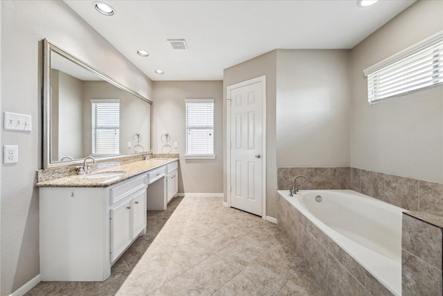 10906 Harvest Sun Dr, Houston, TX 77064 - bathroom featuring a garden tub, healthy amount of natural light, double vanity, and recessed lighting