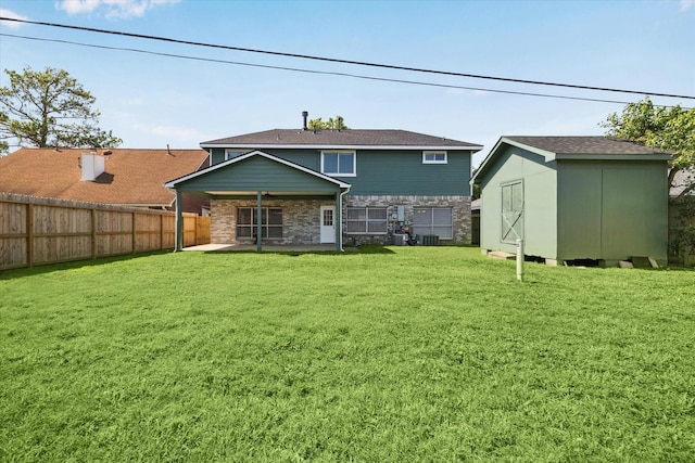 10906 Harvest Sun Dr, Houston, TX 77064 - rear view of property with a storage unit, an outbuilding, stone siding, a patio, and central AC