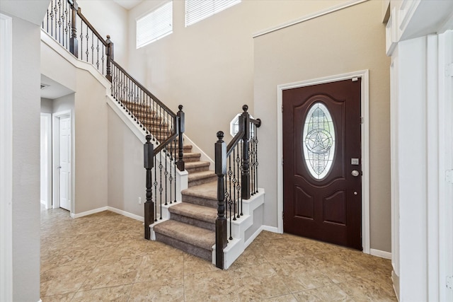 10906 Harvest Sun Dr, Houston, TX 77064 - foyer featuring plenty of natural light, a high ceiling, stairs, and baseboards