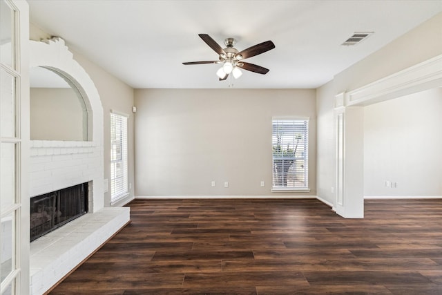 10906 Harvest Sun Dr, Houston, TX 77064 - unfurnished living room featuring healthy amount of natural light, ceiling fan, a fireplace, and wood finished floors