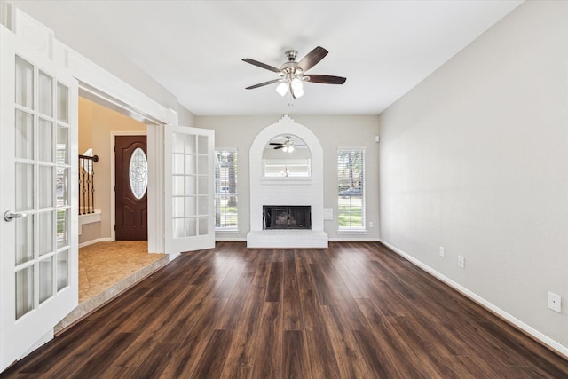 10906 Harvest Sun Dr, Houston, TX 77064 - unfurnished living room with ceiling fan, wood finished floors, a fireplace, and baseboards