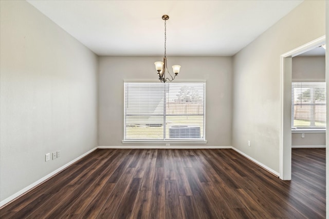 10906 Harvest Sun Dr, Houston, TX 77064 - empty room with a chandelier, baseboards, and dark wood-type flooring