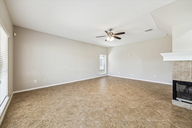 10906 Harvest Sun Dr, Houston, TX 77064 - unfurnished living room with a ceiling fan, a tile fireplace, and baseboards