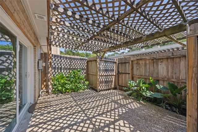view of patio featuring a gate, fence, and a pergola