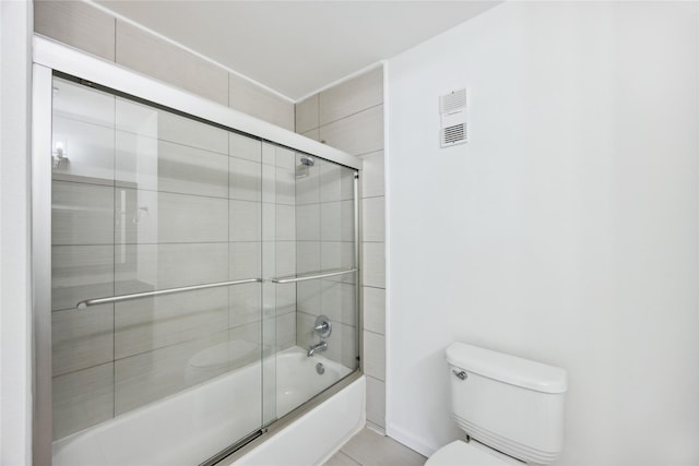 full bath with toilet and shower / bath combination with glass door