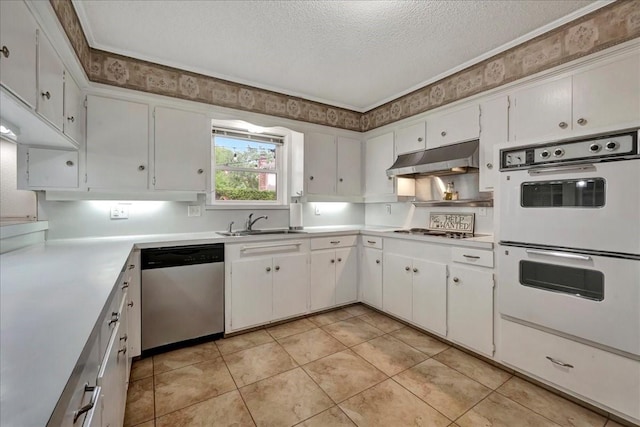 18435 Point Lookout Dr, Houston, TX 77058 - kitchen with stainless steel dishwasher, white double oven, a textured ceiling, a sink, and under cabinet range hood