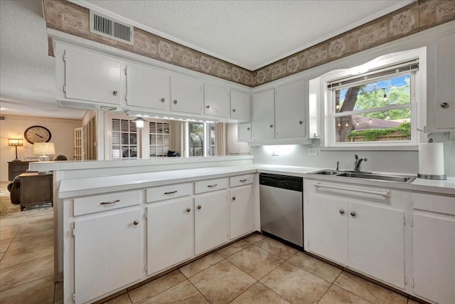 18435 Point Lookout Dr, Houston, TX 77058 - kitchen with stainless steel dishwasher, a textured ceiling, a sink, healthy amount of natural light, and white cabinetry